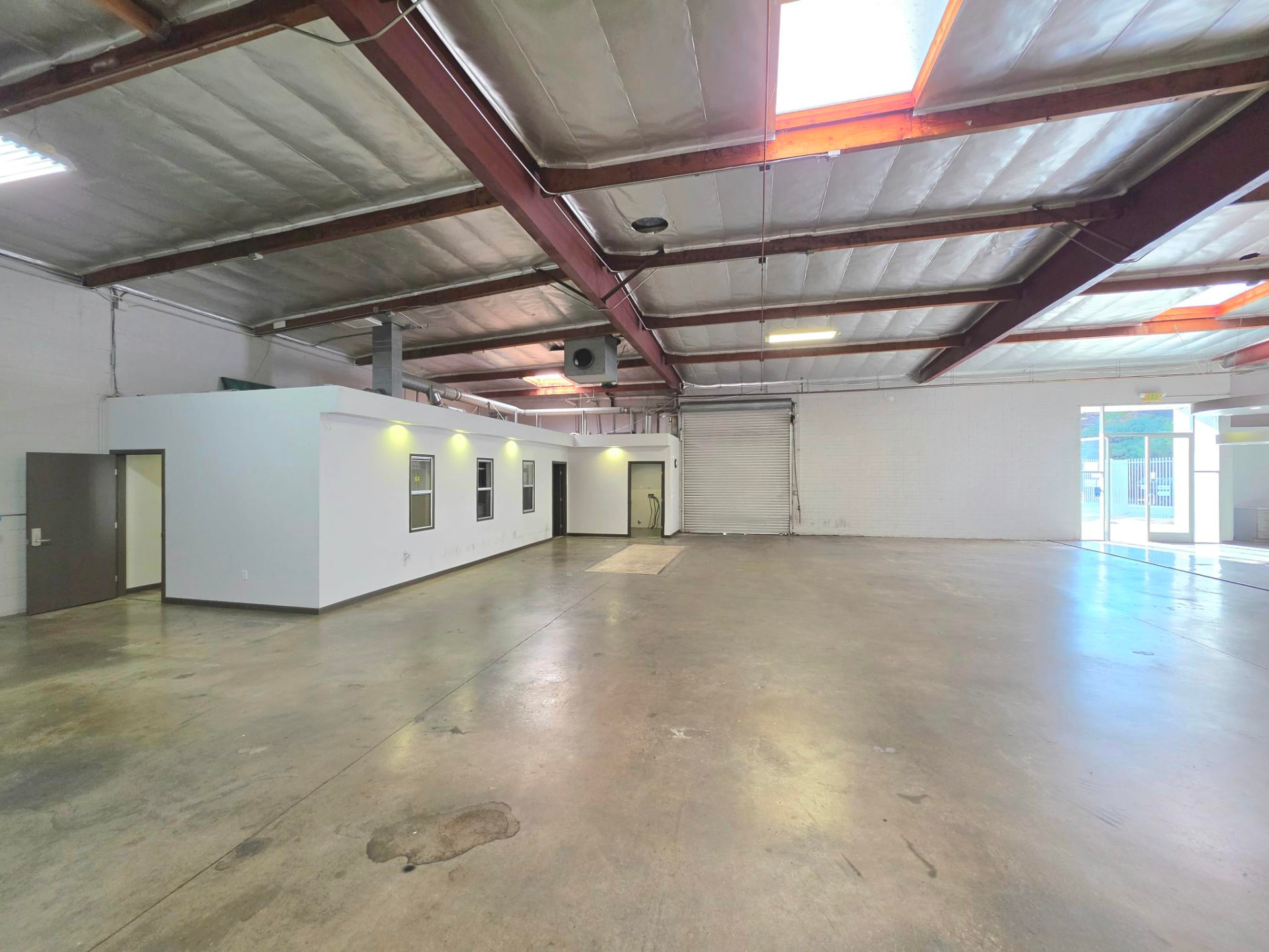 Rear portion of the building with roll-up door and enclosed offices