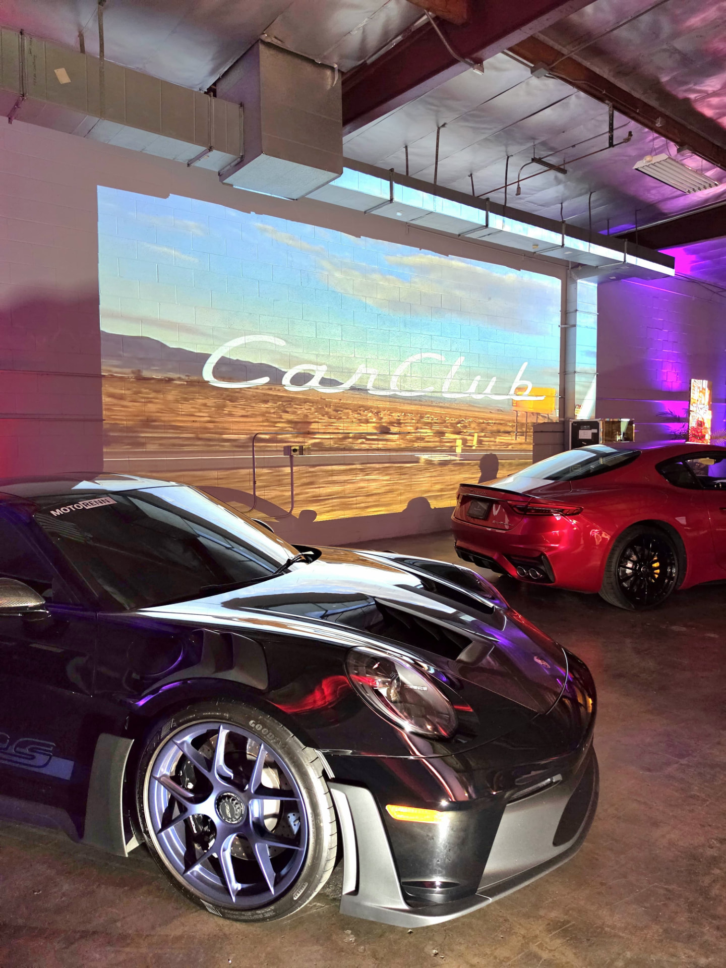 Porsche GT3 RS and Maserati in front of the CarClub desert projection